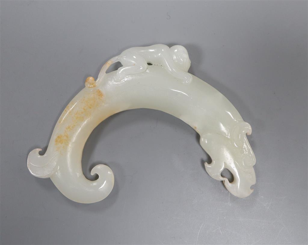 A Chinese archaistic white and russet jade plaque, 9.5cm, carved with a monkey